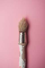 closeup of paint brush on pink background