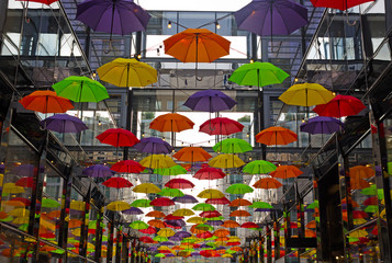 Colorful umbrellas on downtown street in Washington DC, USA. Umbrellas create a cozy friendly atmosphere on the street with shops and restaurants in US capital. - 238394249