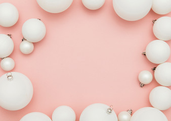 Fototapeta na wymiar Christmas winter composition. White christmas balls on a pastel pink background