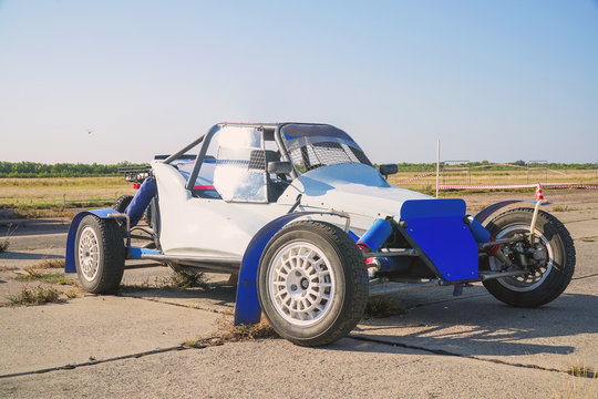 All-wheel drive off-road racing buggy car against the background of a light sky