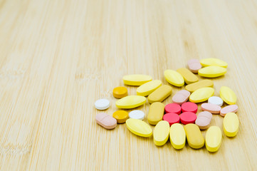 Fototapeta na wymiar Assorted pharmaceutical medicine pills, tablets and capsules on glass bowl