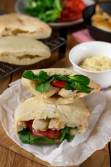 Homemade flatbread pita stuffed with chicken, lettuce and tomato