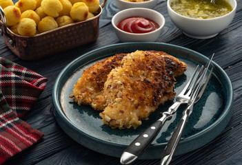 Wiener schnitzel with potato balls and lemon sauce. Chicken schnitzel in breading