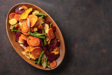 Dried vegetables chips from carrot, beet, parsnip and other vegetables. Organic diet and vegan food.