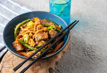 Asian noodles with pork in teriyaki sauce, with green beans, carrots and shiitake mushrooms.
