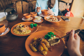 couple eating in cafe. first person point of view
