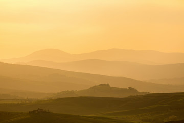 Fototapeta premium Sunset over a rolling landscape