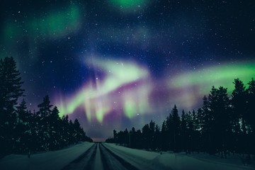 Colorful polar arctic Northern lights Aurora Borealis activity in winter Finland