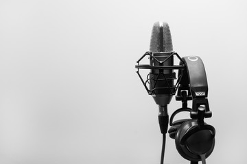 Studio microphone with headphones on a white background. Black and White photo
