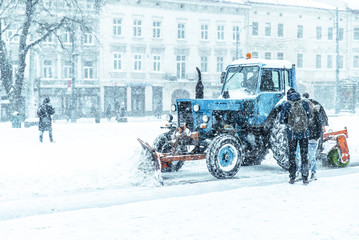 people cleaning city streets after snowstorm