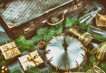 Funny NEW YEAR TRADITIONS ritul walking with empty suitcase at midnigth for have travel. Flat lay