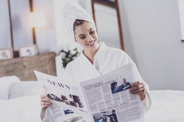 Young woman reading latest news