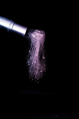 purple and pink powder color splash and brush for makeup artist or beauty blogger in black background, look like a galaxy and mystic mood.