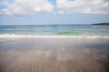 Sea wave and wet sand.The beach of Bali.