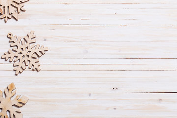 Fototapeta premium Snowflakes on wooden background