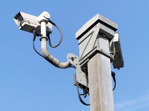 Surveillance camera monitoring motorway traffic on the M25 in Hertfordshire, England, UK
