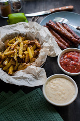 grilled sausages with french fries and vegetables