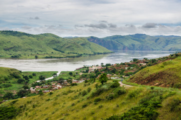 Small village in green hills at Congo River, Democratic Republic of Congo, Africa. - Powered by Adobe
