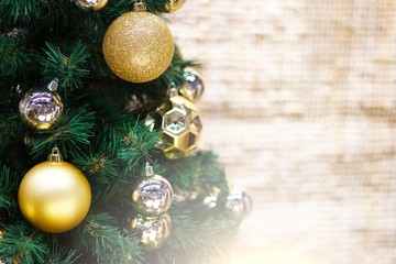Shiny gold and silver christmas balls on white with pine tree
