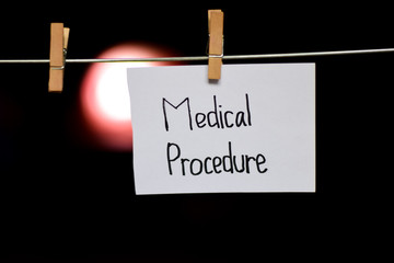 Medical Procedure handwriting on paper. Hanged with a clothes clips, medical and education concept. light blur background