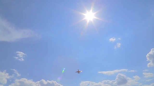 the plane flies through the sun