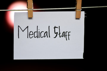 Medical Staff handwriting on paper. Hanged with a clothes clips, medical and education concept. light blur background