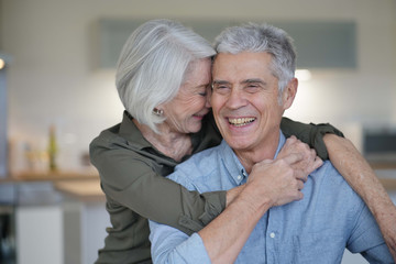  Portrait of loving senior couple in modern home