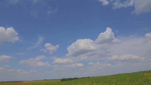 the plane flies over the field