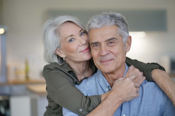  Portrait of loving senior couple in modern home