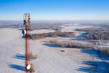 Telecommunications tower with antennas, aerial view.