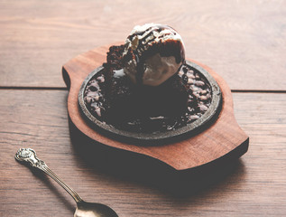 sizzling chocolate brownie is a sweet dish made using scoop of ice-cream on top served with a...