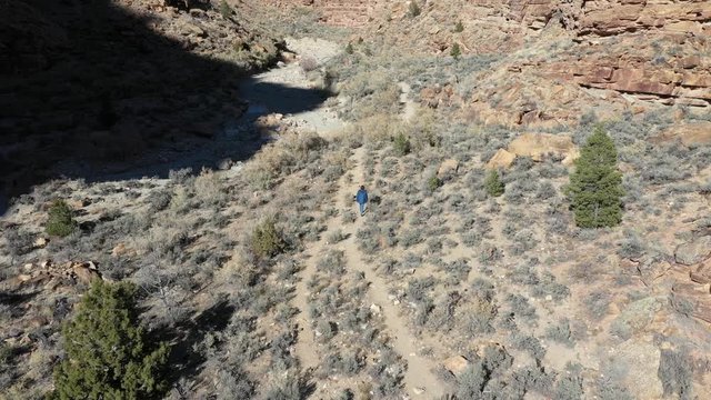 Aerial Woman hike desert mountain Nine Mile Canyon Utah. Nine Mile Canyon, Utah. World&rsquo;s longest art gallery of ancient native American, Indian rock art, hieroglyphs, pictographs and petroglyphs.