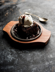 sizzling chocolate brownie is a sweet dish made using scoop of ice-cream on top served with a...