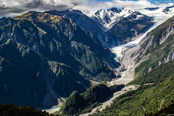 Fototapeta na wymiar Travel New Zealand, beautiful nature/mountain background. Top scenic view of Fox Glacier Valley, Mount Cook and Southern Alps. Popular tourist/backpackers destination.