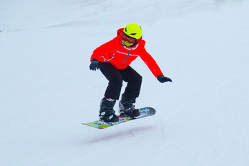 a snowboarder rides a snowboard