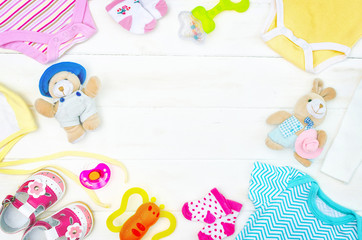 Set of clothing and items for a newborn baby placed on board