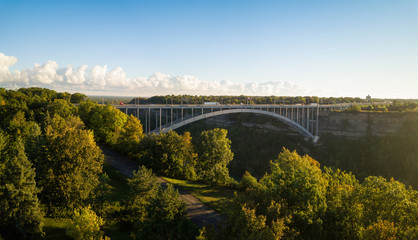 Fototapeta na wymiar Panoramic aerial view of Lewiston-Queenston Bridge across Niagra River during a sunny day. Taken in Niagra Falls, Ontario, Canada.
