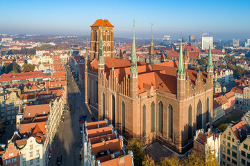 Medieval Gothic Saint Mary Cathedral and Gdansk old city in Poland. Aerial view in sunrise light....