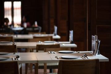 Table set for dinner, with natural light coming in through the windows to the right