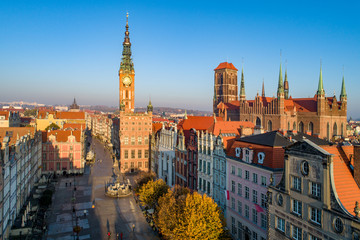 Poland. Gdansk Old City skyline with medieval Gothic Saint Mary Cathedral, city hall with clock tower, Dluga street, Artus Court and Neptune statue with fountain. Aerial view in sunrise light in fall