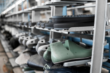 The conveyor on a shoes factory with shoe and sole. Mass production of footwear.