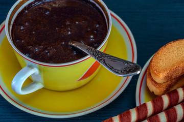 waffle rolls on a plate coffee mug on a dark background