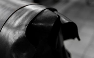 Different pieces of leather in a rolls. The pieces of the colored leathers. Rolls of natural brown...