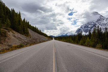 Beautiful road in the Canadian Rockies during Fall Season. Taken in Icefields Pkwy, Banff, Alberta, Canada.