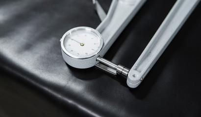 Leather thickness gauge on natural black leather. Preparing of the raw materials for manufacture of bags, shoes, clothing and accessories. © Volodymyr_sh