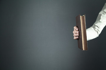 Male hand holding book. Education concept
