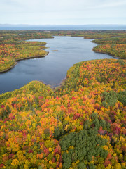 Naklejka premium Aerial view of a beautiful Canadian Landscape during fall color season. Taken near Belledune, New Brunswick, Canada.