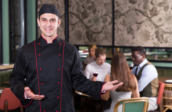 Smiling chef in restaurant hall