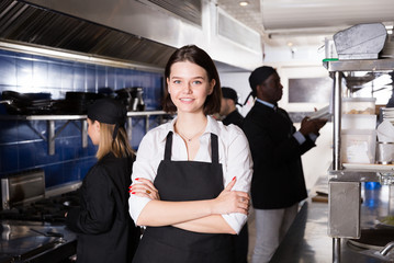 Confident waitress in restaurant kitchen