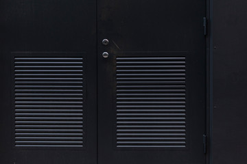 Dark metal door with ventilated doors